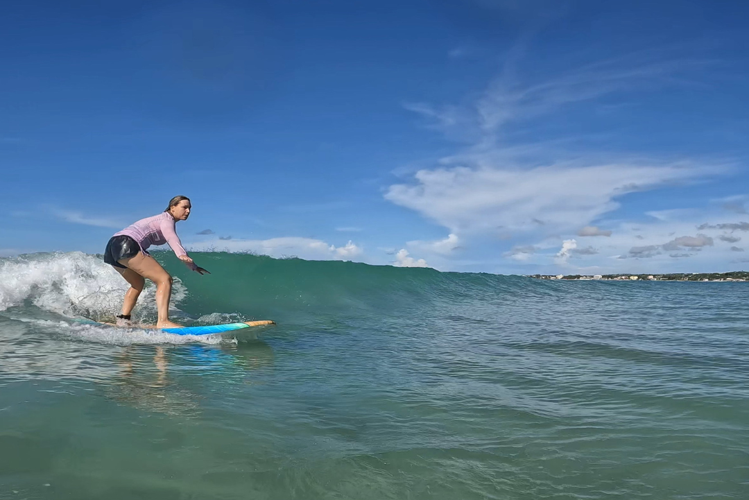 Woman surfing at Frieghts Bay Barbados