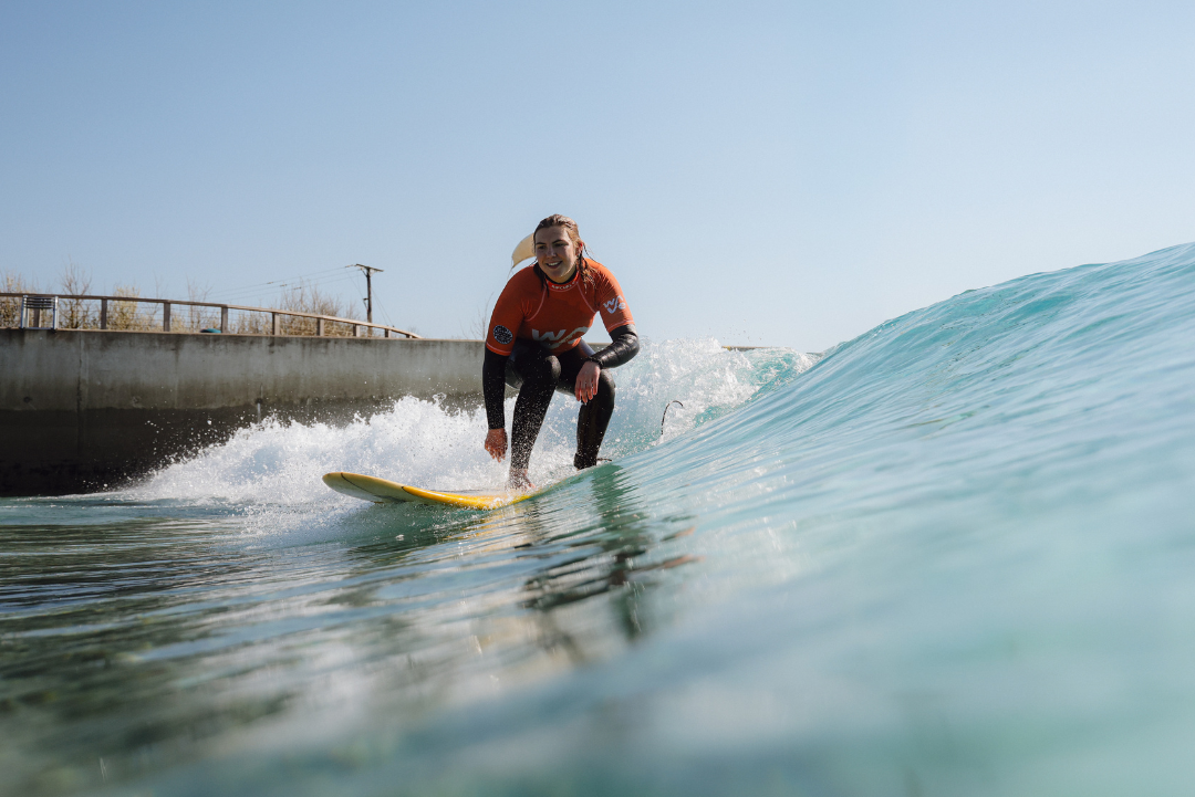 Girl surfing at the wave