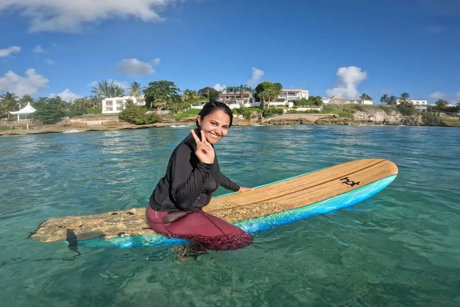 Barbados surf girl sat on board