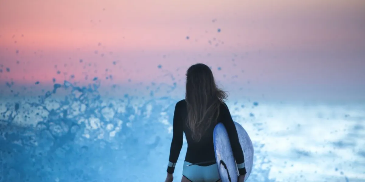 Female surfer watching the waves