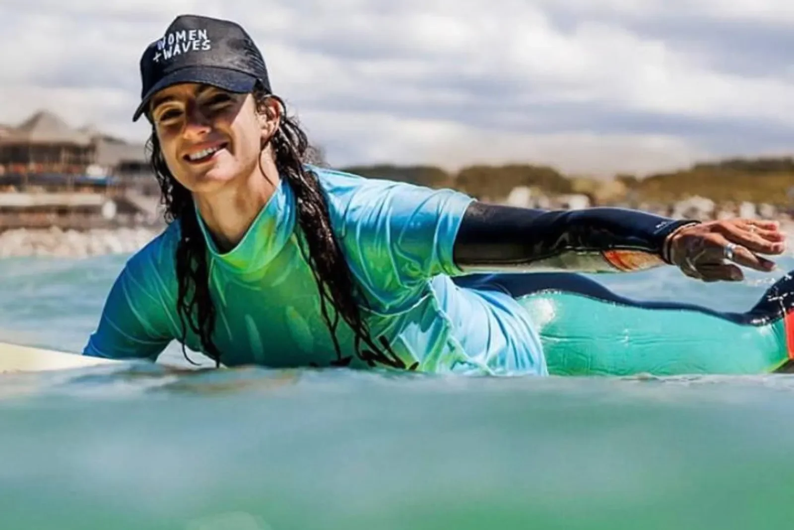 Female surf instructor in the water giving coaching to a guest at Newquay Women and Waves