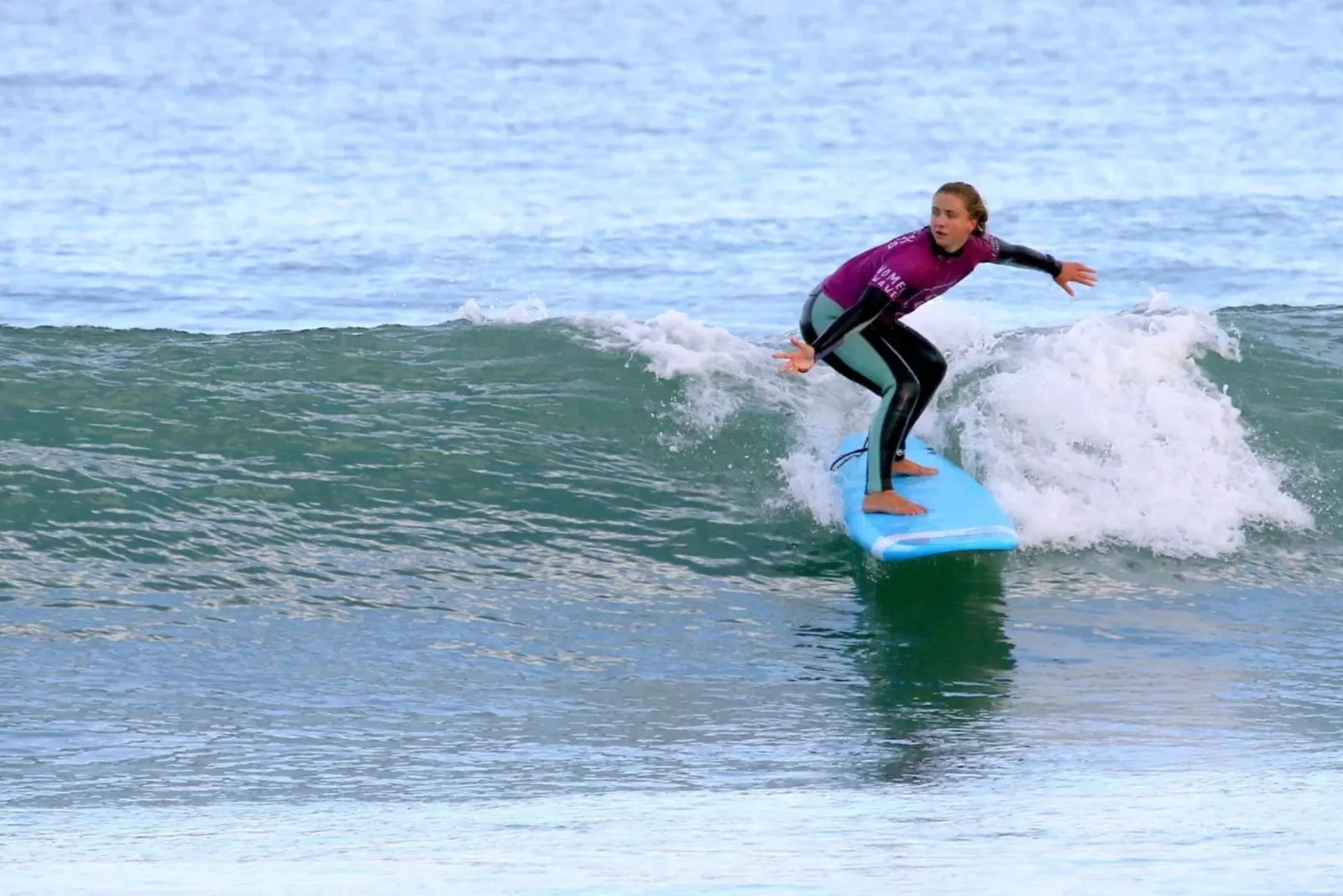 Girl surfer riding surfboard