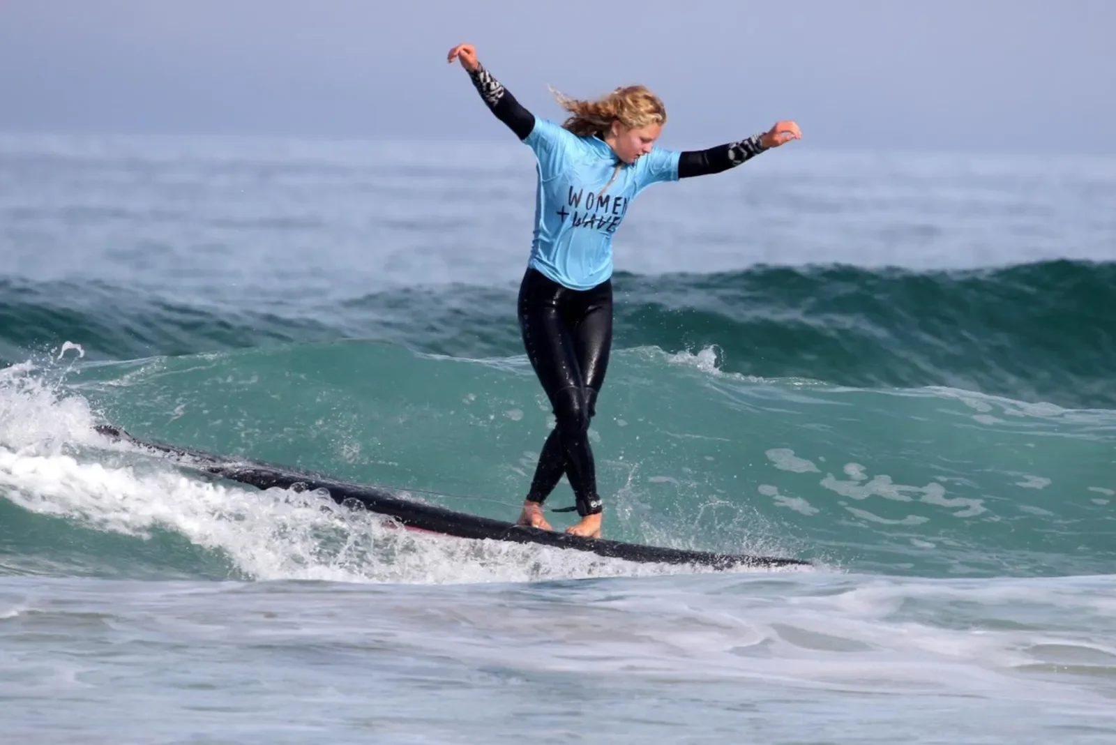 Woman surfer cross stepping