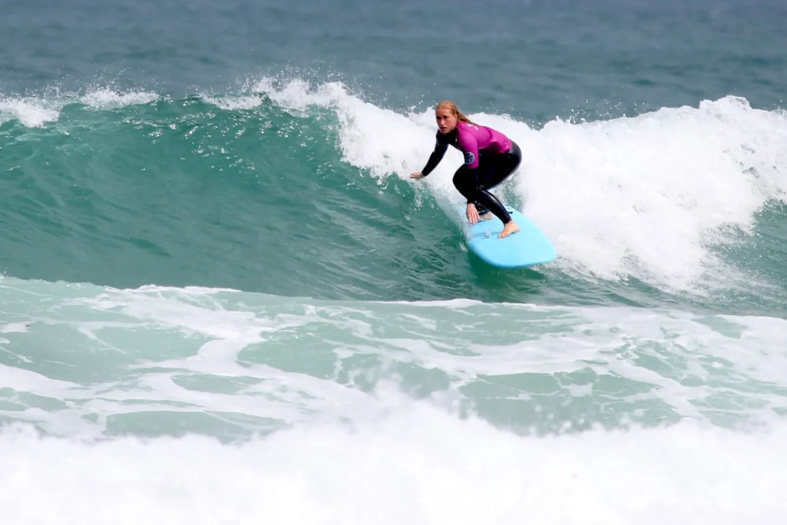 Female surfer bottom turning