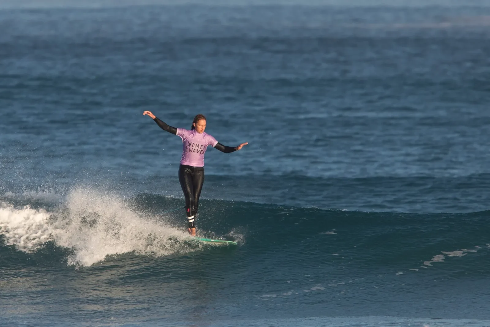 Women surfer on a wave