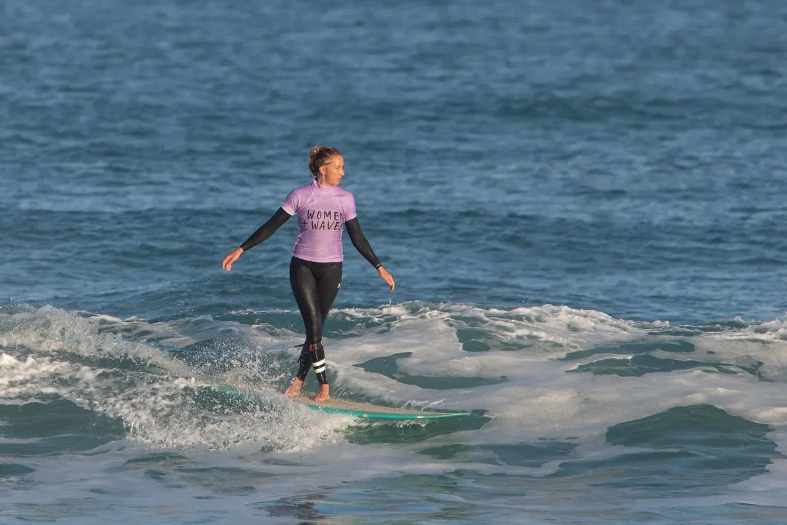 Girl surfer on wave