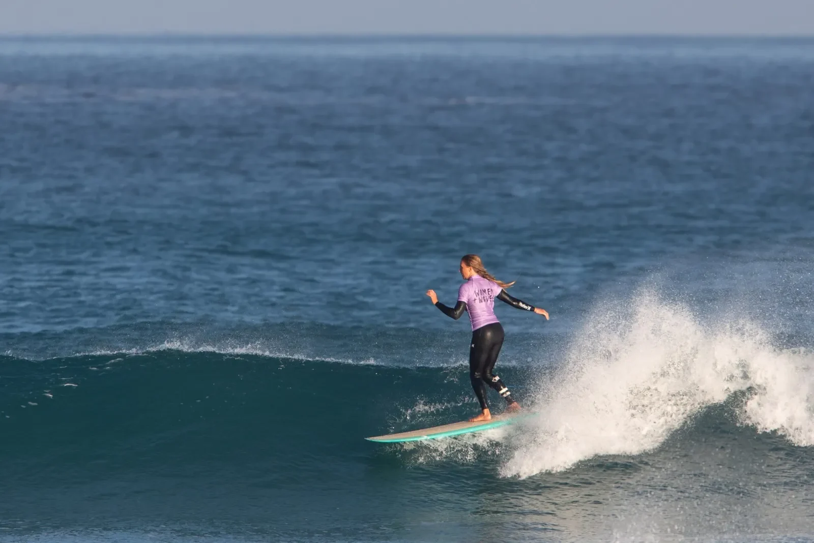 Lady surfer on wave