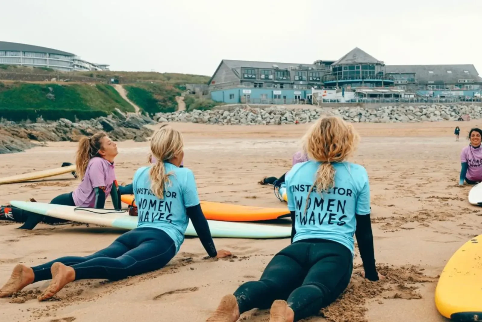 Female surfers stretching on the beach