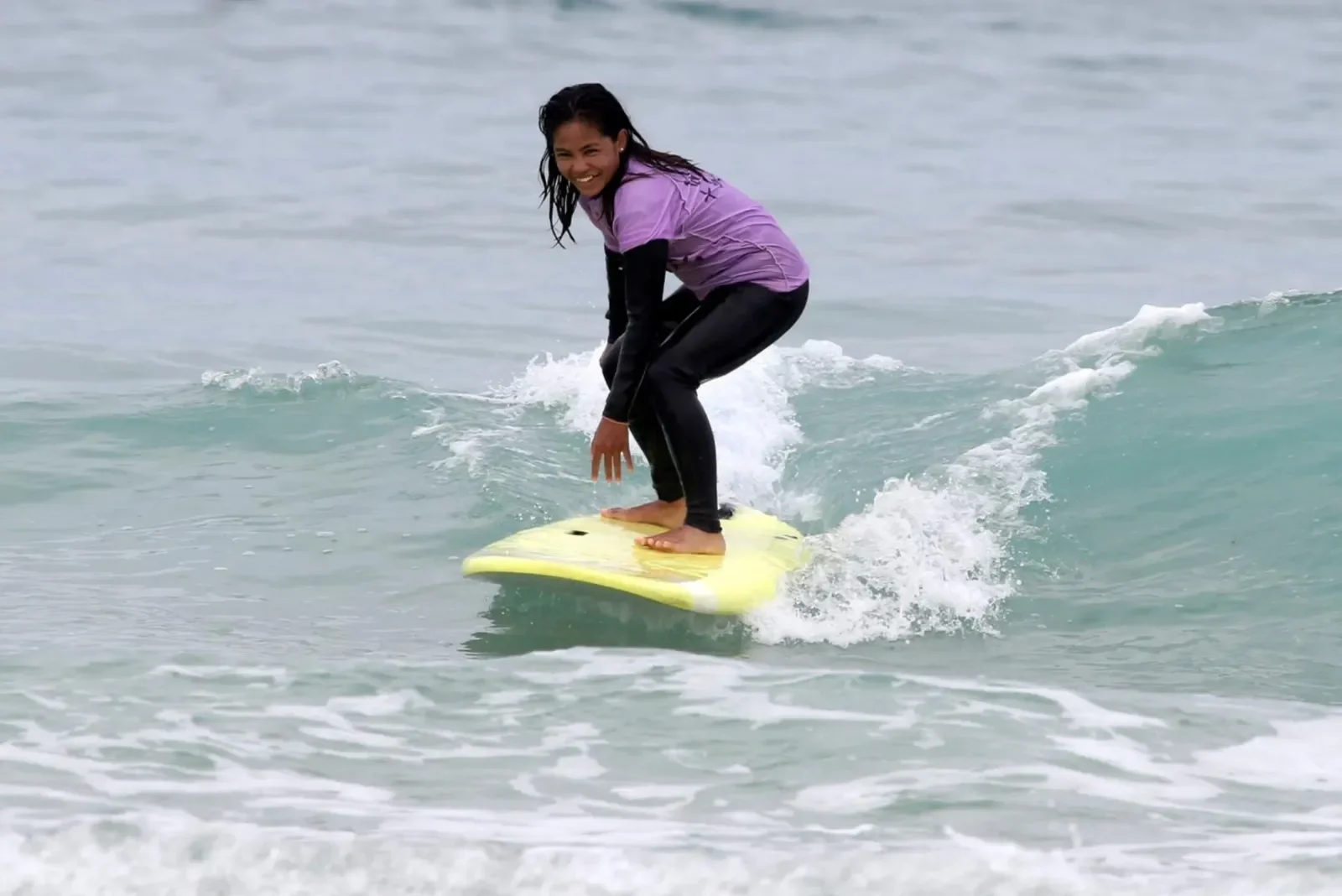 Girl surfer on wave