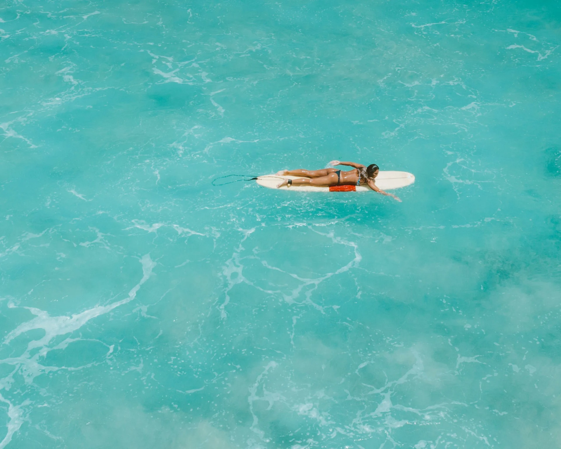 Lady paddling surfboard