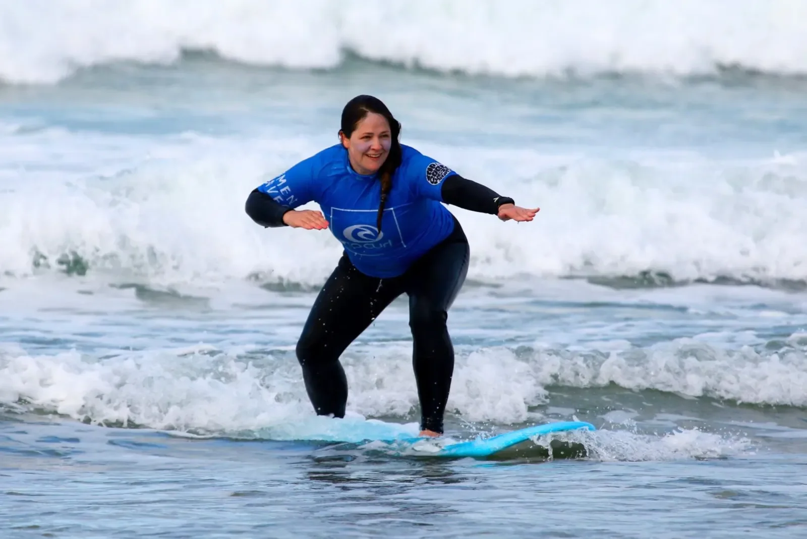 Female surfer riding a wave in Newquay