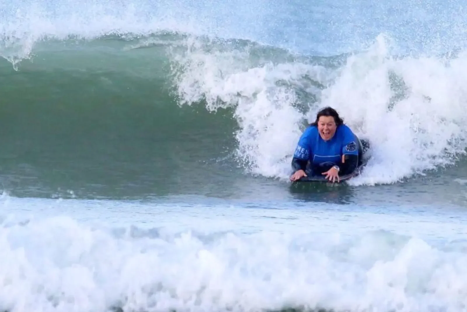 Woman bodyboarding in Newquay